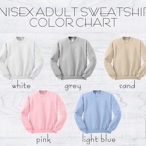 May include: Color chart for unisex adult sweatshirts. The colors shown are white, grey, sand, pink, and light blue.