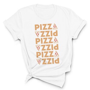 May include: White t-shirt with the word "PIZZA" repeated vertically in a light brown color. Each instance of the word has a pizza slice graphic next to it. The shirt is knotted at the bottom.