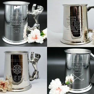 May include: Four silver pewter tankards with different engravings. The tankards have a lion head handle. The engravings include a compass, a birthday message, and a golf club.