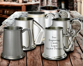 May include: A collection of six pewter tankards with various designs. The tankards are silver in color and have a polished finish. The tankards have different handles, including a golf club, a lion, and a scroll design. The tankards are arranged on a wooden table. The text "Free Engraving Crests Logos Vector Designs" is printed on the table.