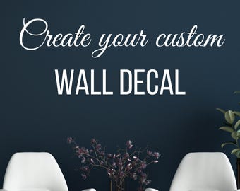 May include: Create your custom wall decal, a white text phrase on a dark blue wall with two white chairs and a vase of flowers in the foreground.