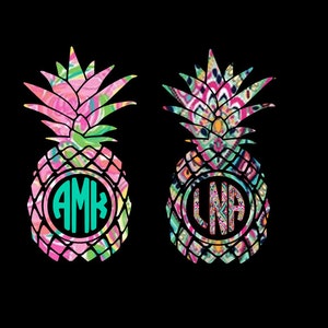 May include: Two pineapples with colorful patterned designs and black outlines. Each pineapple has a circle with a monogram inside. The monogram on the left pineapple is AMK and the monogram on the right pineapple is LNA.