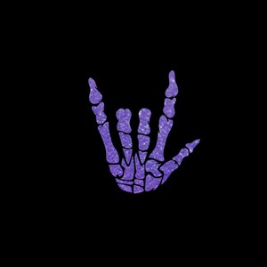 May include: A purple glitter skeleton hand making the rock and roll hand gesture against a black background. The hand is detailed with visible bones and a sparkling texture, creating a striking contrast.