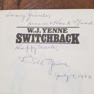 May include: A book cover with the title "SWITCHBACK" in large, bold, dark letters. The author's name, W.J. YENNE, is above the title. Handwritten inscriptions and signatures in blue ink are present, including the date July 19, 1983.