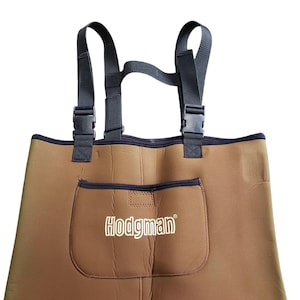May include: Brown Hodgman waders with black adjustable straps and buckles. The waders have a front pocket with the Hodgman logo in white. The waders are designed for water activities like fishing and hunting.
