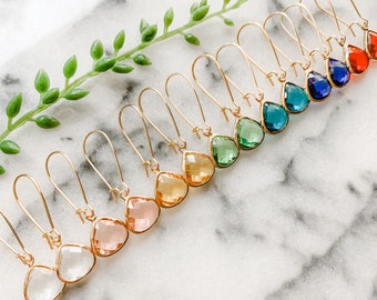 May include: A set of 10 pairs of gold teardrop earrings with faceted glass stones in various colors, including clear, green, blue, and pink.