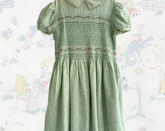 Vintage 1950s Green Brushed Cotton Smocked Girls Dress Novelty Fairy Print with Embroidered Roses | Apron Size 9-10