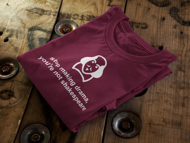May include: Burgundy t-shirt with a white graphic of a person with a crown and the text "stop making drama, you're not shakespeare".