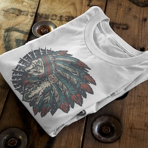May include: White t-shirt with a vintage-style illustration of a Native American headdress with feathers in shades of blue, red, and green.