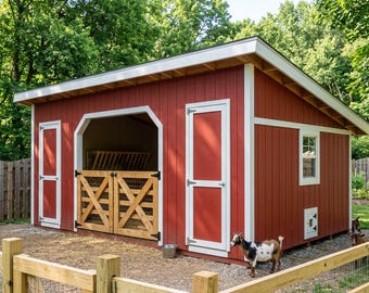 May include: A red wooden shed with white trim, featuring a slanted roof, two solid side doors, and a central open stall with wooden cross-braced gates. A small window and a lower access door are visible on the side, with a goat standing nearby.