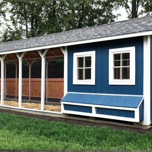 May include: A blue and white chicken coop with a grey roof. The coop has a covered run with wooden and wire mesh sides. The coop has two windows and a door with an X design. The coop is on a green lawn.
