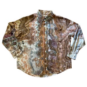 May include: A button-down shirt with a unique tie-dye pattern in shades of brown, tan, and blue. The long-sleeved shirt features a chest pocket and a classic collar. The shirt is made of a soft, comfortable material.