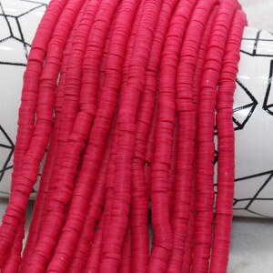 May include: A strand of bright pink round polymer clay beads. The beads are stacked on top of each other and are about 1/2 inch in diameter.