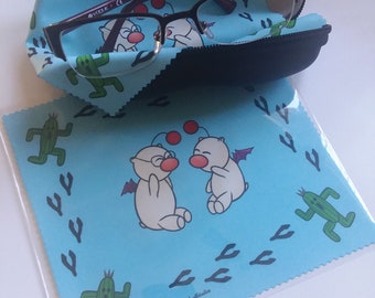 May include: A blue microfiber cleaning cloth with a repeating pattern of green cacti and footprints. The cloth features two white cartoon characters with wings and red balls. The text "Chibi Studio" is printed in the bottom right corner.