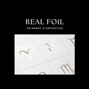 May include: Gold foil zodiac signs on white cards. The signs are Aries, Taurus, Gemini, Cancer, Leo, Virgo, Libra, Scorpio, Sagittarius, Capricorn, Aquarius, and Pisces.