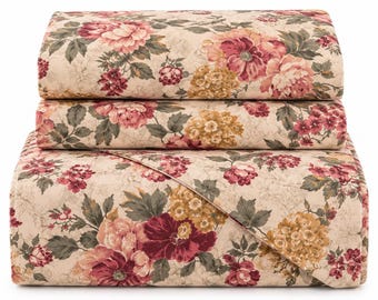 May include: A bedding set featuring a cream-colored base with a dense floral pattern in shades of deep red, muted pink, golden yellow, and sage green. The set includes a folded comforter and two matching rectangular pillow shams.