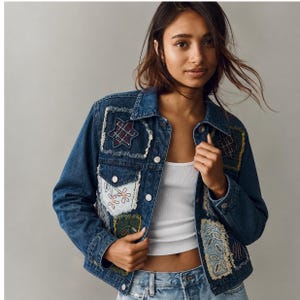 May include: A blue denim jacket featuring various rectangular and star-shaped patches with frayed edges. The patches display diverse patterns including plaid, floral embroidery, and leaf motifs. The jacket has a classic collar and silver buttons.