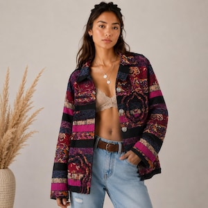 May include: A long-sleeved button-down jacket featuring a patchwork design with horizontal stripes in shades of magenta, black, and deep purple, accented by intricate floral patterns and textured fabric panels throughout the garment.