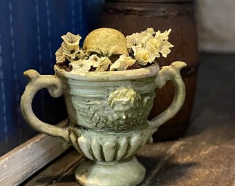 Miniature buried secrets skull in planter haunted mystery dollhouse