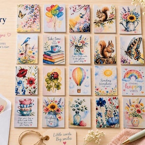 May include: A collection of twenty rectangular mini stationery cards featuring watercolor illustrations of flowers, animals, butterflies, and landscapes, with some cards displaying text such as Take time for YOU and Sending Sunshine.