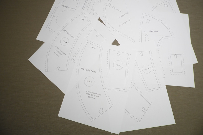 May include: A set of sewing patterns for a garment with instructions for cutting and sewing. The patterns include measurements for different sizes. The patterns are printed on white paper.