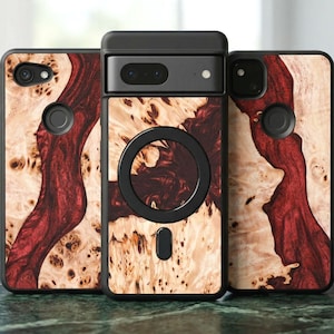May include: A collection of phone cases with a natural wood grain design. The cases feature a black border and a striking pattern of light brown and deep red hues. The cases are displayed on a green marble surface.
