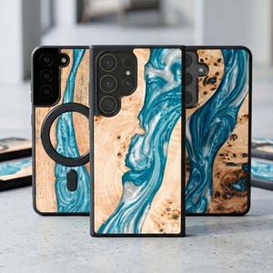 May include: A collection of phone cases with a unique design. The cases feature a combination of light wood grain and flowing blue resin. The cases have a black border and are designed for various phone models.
