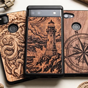 May include: Three smartphone cases with black frames and wood-grain back panels. The left case features an octopus and anchor engraving. The center case displays a lighthouse on a rocky shore. The right case shows a compass rose with cardinal directions.