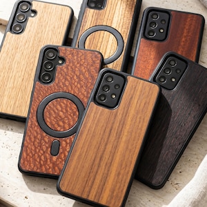 May include: A collection of wooden phone cases in various shades of brown, from light oak to dark walnut. The cases have black borders and feature camera cutouts. Some cases have a circular magnetic attachment.
