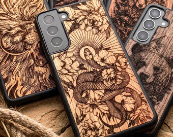 May include: Wooden phone cases with intricate laser-cut designs. One case features a snake coiled among flowers, another a lion's face, and others depict a bear, and a forest scene. The cases have a natural wood grain finish and black borders.