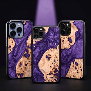 May include: Three phone cases with a striking design. The cases feature a black frame and a unique pattern of swirling purple and tan wood grain. The cases are designed to fit different phone models and offer both style and protection.
