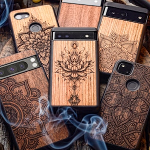 May include: Several wooden phone cases with detailed laser-cut mandala and floral patterns. The cases are various shades of brown and have black edges. The designs include a large lotus flower and other geometric patterns.
