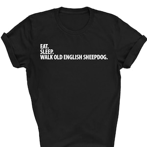 May include: Black t-shirt with white text that reads "Eat. Sleep. Walk Old English Sheepdog."