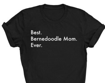 May include: Black t-shirt with white text that reads "Best. Bernedoodle Mom. Ever."