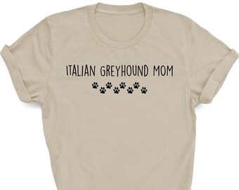 May include: A beige t-shirt with the text "ITALIAN GREYHOUND MOM" and a row of paw prints below the text.