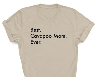 May include: A beige t-shirt with the text "Best. Cavapoo Mom. Ever." printed in black.