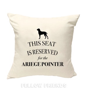 May include: A white throw pillow with black text that reads "This seat is reserved for the Ariege Pointer" and a black silhouette of a dog.