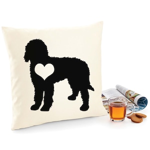 May include: A white pillow with a black silhouette of a dog with a white heart in its chest.