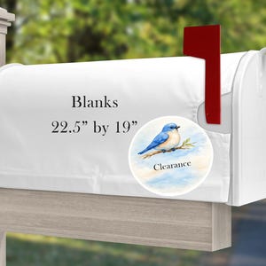 May include: A white mailbox cover measuring 22.5 inches by 19 inches, featuring the text Blanks and a circular graphic of a bluebird perched on a branch with the word Clearance printed below it, complete with a red metal signal flag on the side.