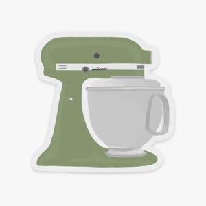 May include: A sticker featuring a green stand mixer with a silver mixing bowl. The mixer has a classic design with a tilt-head and a handle on the bowl. The sticker is a simple illustration, perfect for kitchen decor or baking enthusiasts.