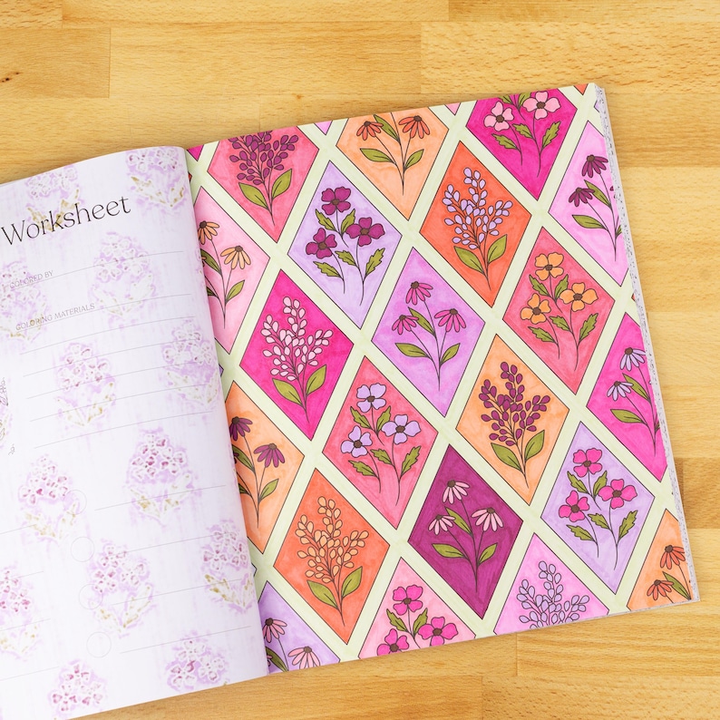 May include: Open notebook with a floral design. The right page features a repeating pattern of flowers in diamond shapes, with pink, orange, and purple hues. The left page has the word "Worksheet" and a floral pattern.