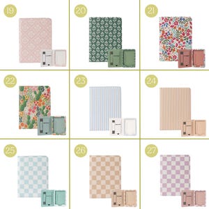 May include: A collection of notebooks and phone stands in various patterns and colors. The notebooks feature floral, striped, and checkered designs. The phone stands are in matching colors. The notebooks are approximately 8 inches tall.