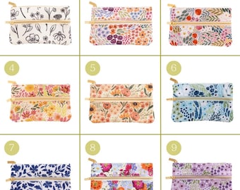 May include: Nine small, rectangular zippered pouches with floral patterns. The pouches feature various designs, including black and white line drawings, colorful blooms, and blue and white leaf patterns. Each pouch has a gold-colored zipper.