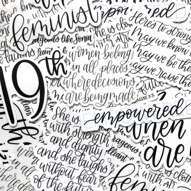 May include: A collection of black and white stickers with feminist and empowering messages. The stickers feature phrases like "feminist", "she is empowered", "women belong in all places where decisions are being made", and "may we know our future".