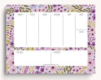 May include: A weekly planner with a floral design in shades of purple, pink, and green. The planner has sections for each day of the week, a to-do list, and a notes section. The text "elysesbreannedesign.com" is at the bottom of the planner.