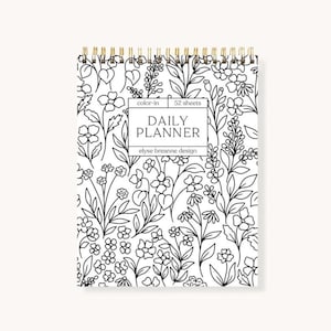 May include: A spiral-bound daily planner with a black and white floral pattern. The cover displays a repeating design of flowers and leaves. The planner includes the text "Daily Planner" and "elyse breanne design". It has 52 sheets and is designed for colouring.