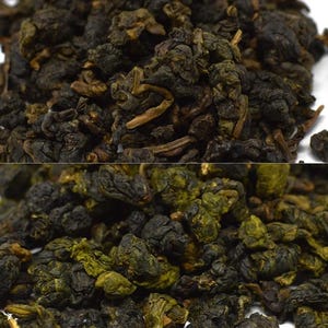 May include: Close-up of loose-leaf tea, showcasing a mix of dark green and brown leaves. The tea leaves have a tightly rolled appearance, suggesting a high-quality product. The image highlights the texture and color variations of the tea.