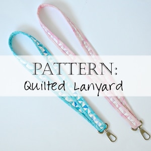 May include: Two quilted fabric lanyards, one pink and one blue, with silver swivel clasps.  PATTERN: Quilted Lanyard
