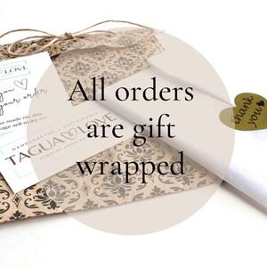 May include: A brown paper bag with a patterned design and a white gift tag that says "Thank you for your order". The bag is tied with twine and has a sticker that says "TAGUA LOVE". The text "All orders are gift wrapped" is written in black on a white circle.