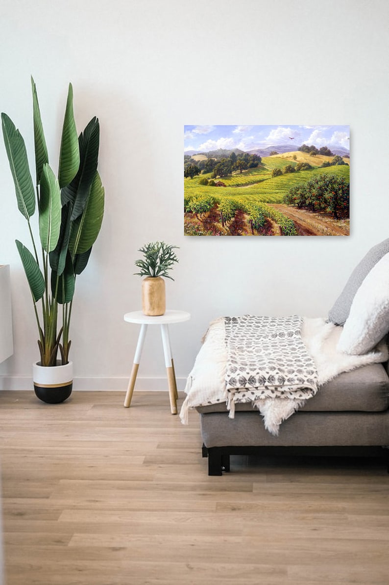 May include: A painting of a vineyard landscape with rolling hills, green vines, and a blue sky with white clouds. A small red airplane flies in the distance.